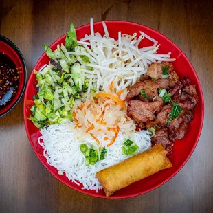 a red plate with rice, meat, and vegetables