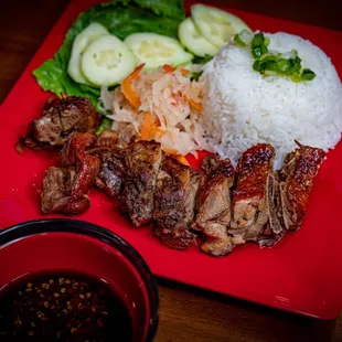a plate of meat, rice, and vegetables