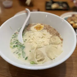 Tonkotsu Cheese Ramen. Pork broth with fried garlic chips and a generous pile of grated parmesan!