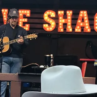 a man with a hat playing guitar