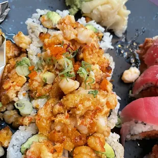 a plate of sushi with shrimp and vegetables