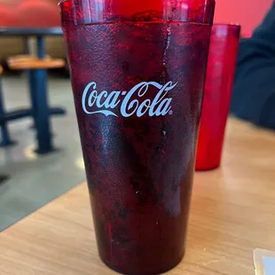a glass of coke on a table