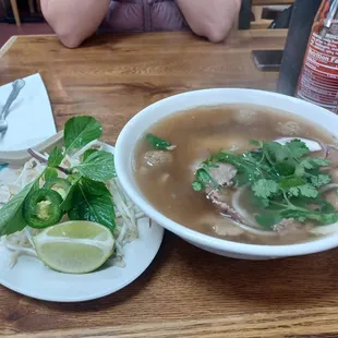 a bowl of soup and a plate of noodles