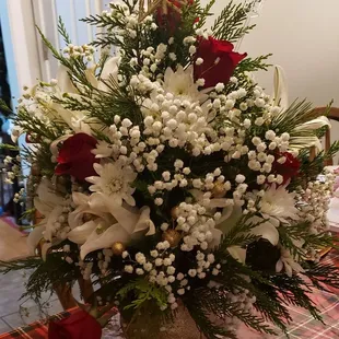 Roses, babys breath, cedar, white lily ornamentmental decoration
