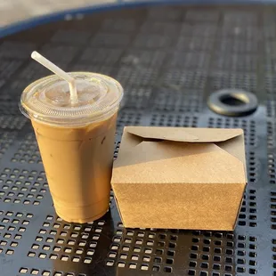 a cup of coffee and a takeout box