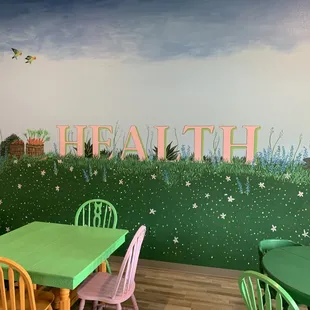 a green table and chairs in a children&apos;s playroom