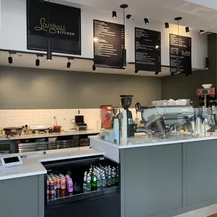 a coffee shop counter with menus on the wall