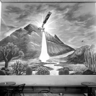 a black and white photo of a mural