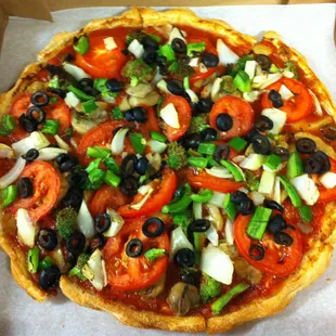 veggie pizza without cheese. Onions, Green Peppers, Mushrooms, Black Olives, Tomatoes, Broccoli, and Artichoke