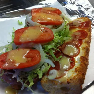 ITALIAN SUB: with Ham, Salami, Pepperoni, lettuce, onion, tomatoes, topped with mozzarella and provolone cheese and Italian dressing