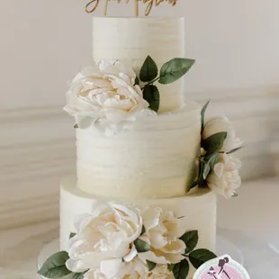 a white wedding cake with flowers