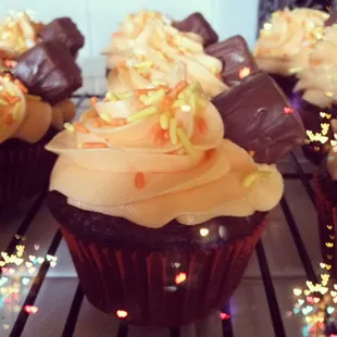 a chocolate cupcake with frosting and sprinkles