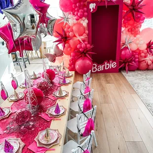 Barbie box and kids set up with tables, chairs, goodie bags and table setting