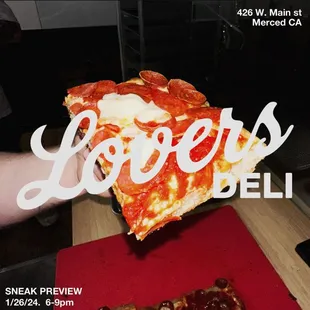 a person holding a slice of pizza