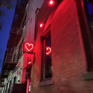 Find the neon heart and go down the staircase.