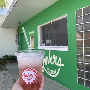 a hand holding a drink