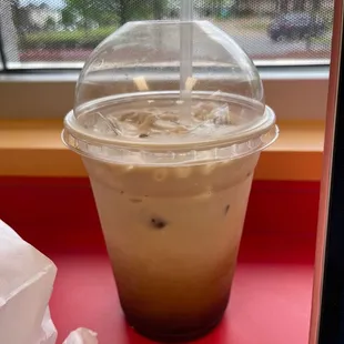 a plastic cup of iced coffee