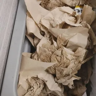 a trash can filled with paper