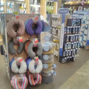 Neck pillows surrounded by phone accessories