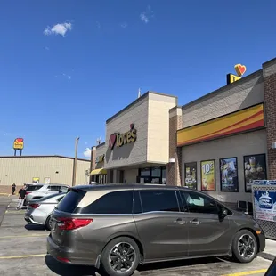 a car parked in front of a fast food restaurant