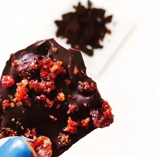 a hand holding a piece of chocolate