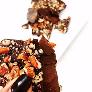 a hand holding a piece of chocolate