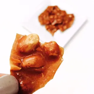 a hand holding a piece of food