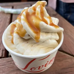 a cup of ice cream with caramel drizzle