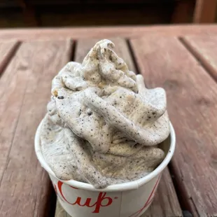 a cup of ice cream on a wooden table