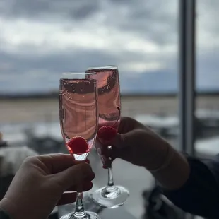 two people toasting with wine glasses