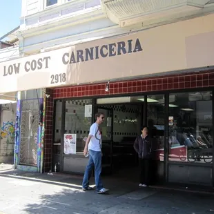 people standing outside a store