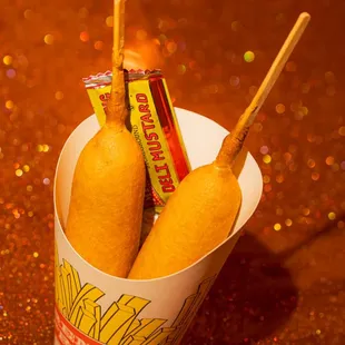 two hot dogs in a paper cup