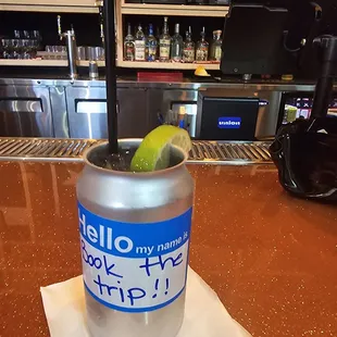 a drink in a can with a lime in it