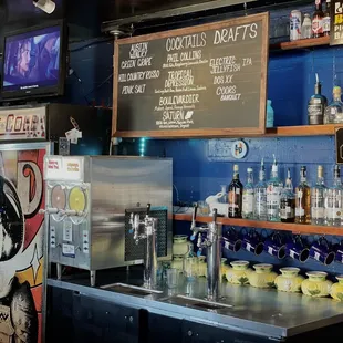 a bar with drinks on the counter