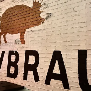 a pig on a brick wall