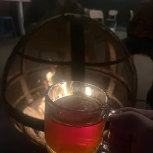 a person holding a glass of tea