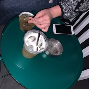 a person sitting at a table with drinks
