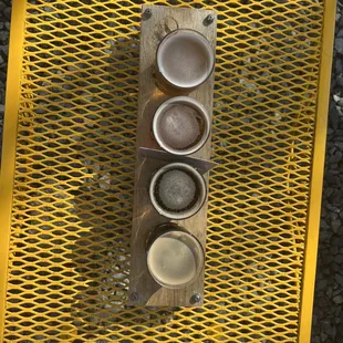 three cups of beer on a wooden board