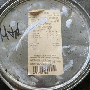 Old paint can lid with formula.