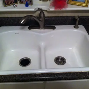 Kohler cast iron sink, love it. Faucet.  Half moon where they had to cut out the window sill so the faucet would fit