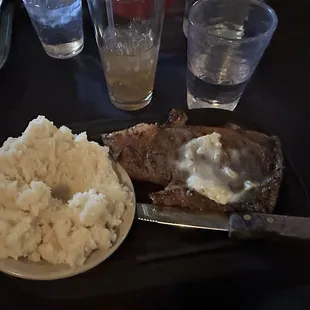 Ribeye steak with mashed potatoes.
