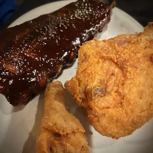 a plate of fried chicken and ribs