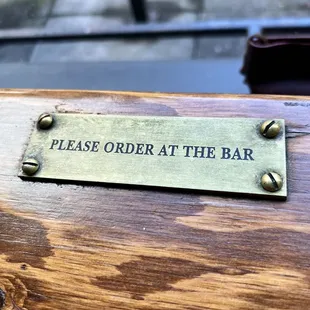 a sign stating to order at the bar