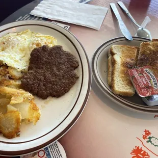 Eggs over medium, sausage with sourdough toast
