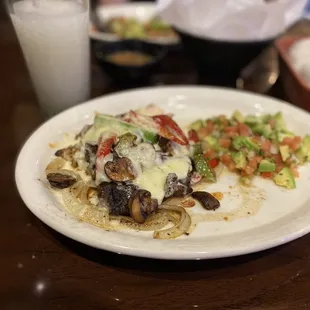 Special fajitas with chicken, steak, vegetables, cheese and mushrooms.