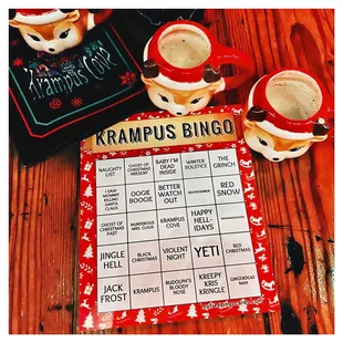 two cups of coffee and a game card