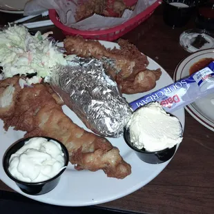 Fried Walleye with baked potatoe, tartar sauce, whipped butter and sour cream.