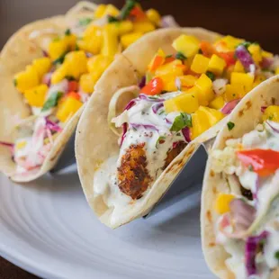 three fish tacos on a plate