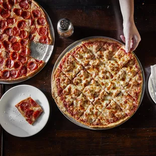 two pizzas on a table