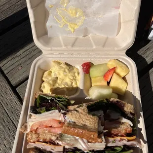 3/4 Garden-Style Club Sandwich with egg &amp; potato salad and fruit.